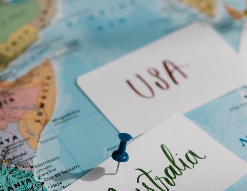 Detailed close-up of a world map with USA and Australia labeled, highlighted with pins.
