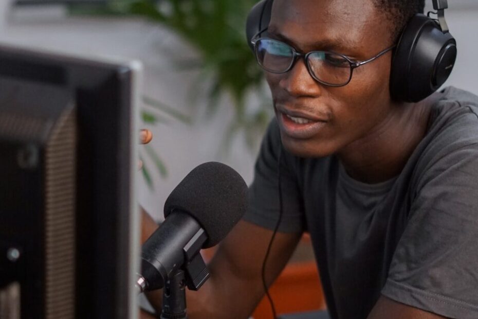 a man wearing headphones sitting in front of a computer